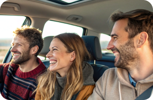 People in a car smiling
